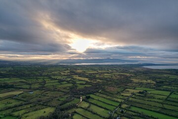 landscape of approaching storm, dramatic sky over countryside, coming summer rain, green grass, black clouds, aerial view, drone photo