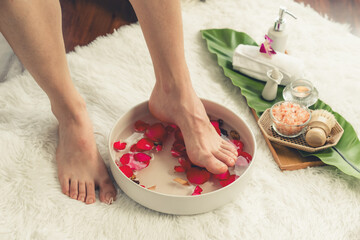 Woman indulges in blissful foot massage at luxurious spa salon while masseur give reflexology...