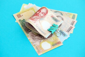 Vietnamese dong money bills in big amount close up on blue. Finance and banking concept