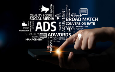 A conceptual image showcasing digital marketing and advertising strategies, featuring a hand pointing at a tablet surrounded by relevant keywords against a dark backdrop. Tessel