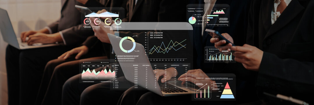 Business professionals engage in data analysis using laptops and smartphones in a modern office, surrounded by digital visualizations and graphical representations. Trope