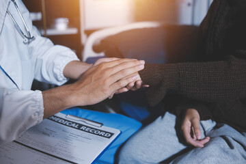 A female nurse caregiver holds hands to encourage and comfort an elderly woman. For care and trust in nursing homes for people of retirement age Caregiver helping elderly woman provides medical advice