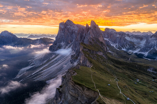 Aerial view of spectacular sunrise at the Seceda mountain ridge line in the Italian Dolomites cloud inversion and golden light