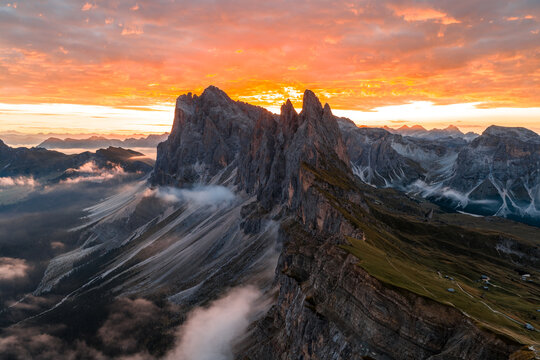 Aerial view of spectacular sunrise at the Seceda mountain ridge line in the Italian Dolomites cloud inversion and golden light