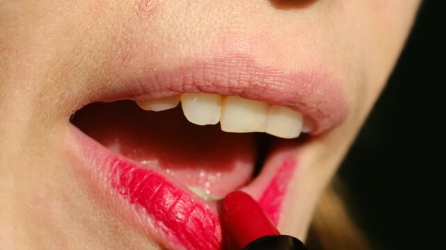 woman applying lipstick, elegant woman ready for shoot, detailed macro of woman enhancing lips with glossy color, glamorous woman preparing her lips with precise makeup for photoshoot session