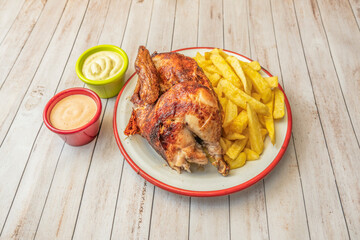 fried chicken on truffle mashed potatoes with crispy potato chips, presented gourmet-style on a white plate