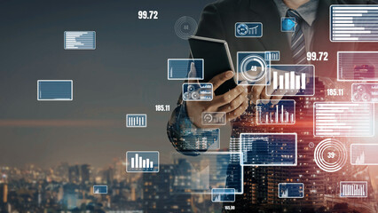 A business professional interacts with a digital tablet, surrounded by holographic data overlays that reflect modern finance and technology in an urban environment. Xenic