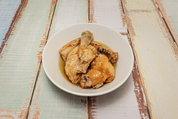 A dish of garlic chicken in a white bowl
