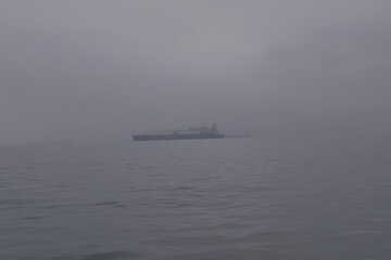 Fishing boats in the fog in the Pacific Ocean near Paracas, Peru