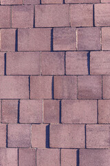  The wall is made of bricks and has a rough texture