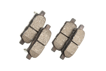 New front car brake pads with dark gray friction material and a metal base, against a white studio background. Close-up