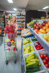 Mother and daughter grocery shopping for healthy food