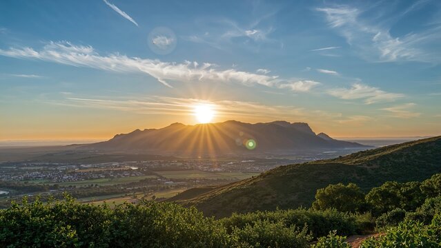 Sunset over the mountains with a bright full moon in the sky, displaying a scenic landscape with clouds, hills, and greenery.