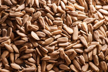 Peeled sunflower seeds filling the frame, creating a nutritious background and healthy snack texture