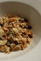 Granola mix with oats, nuts, seeds, and dried fruit for a healthy breakfast. Cotswolds countryside, England