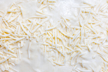 Close-up texture of shredded white cheese