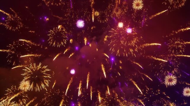 Bright orange and purple fireworks exploding in a dark night sky, 4k festive celebration loop video