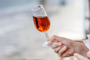 Hand holding catavino glass with oloroso sherry