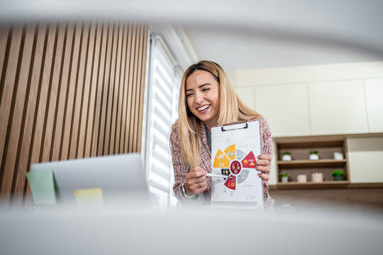 Woman presenting business data during a remote video call