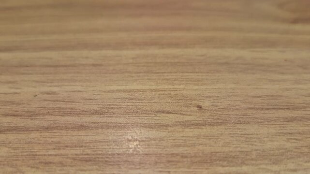 Closeup forward view of floor wood pattern highlights grain design, smooth polish, and linear arrangement.