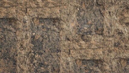 Fototapeta premium Close-up of textured brown and dark gray stone wall.