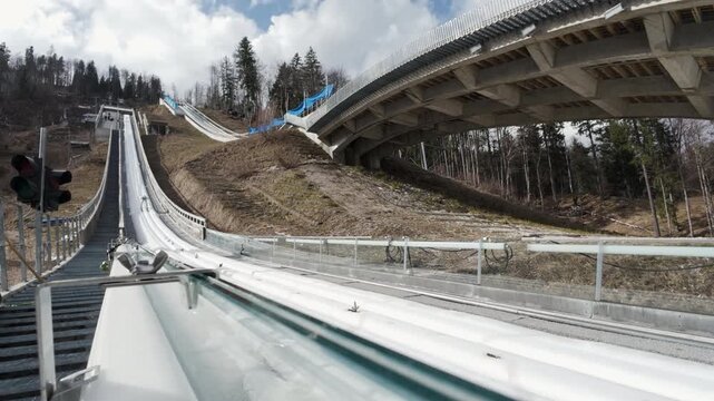 Male competitor practicing at the Nordic Winter Center in Planica Slovenia in preparation for the ski jumping World Cup Finals, static shot