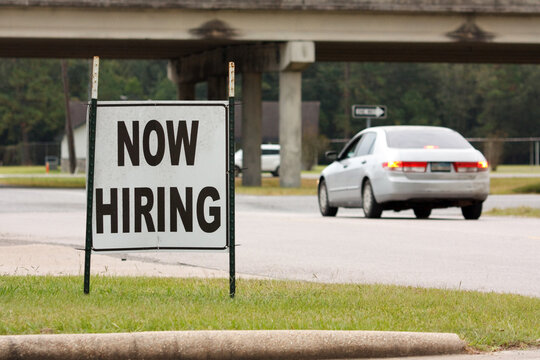A now hiring sign placed near a highway in Beaumont, Texas is advertising for jobs available