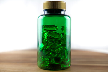 Green plastic bottle with vitamins