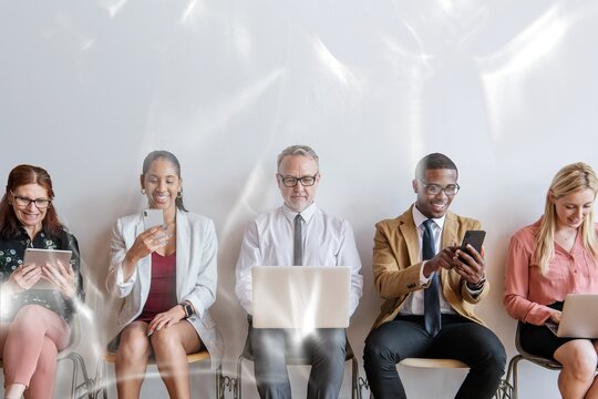 Diverse business people using digital devices