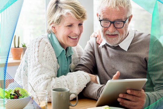 Happy senior couple using tablet remix - Powered by Adobe
