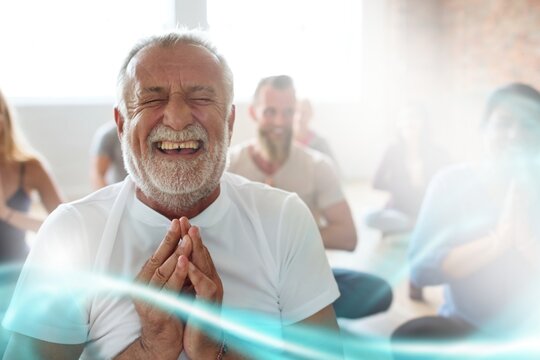 Smiling old man in yoga class