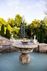A classical stone fountain with flowing water in the central cascade of Valea Morilor Park in Chisinau, Moldova. 