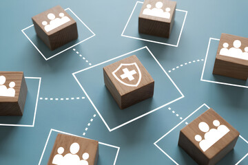 Wooden blocks with people and shield icons represent network security healthcare and community protection on a blue background symbolizing safety and connection in a modern design
