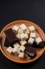 Chocolate covered marshmallows and sweet cubes for dessert