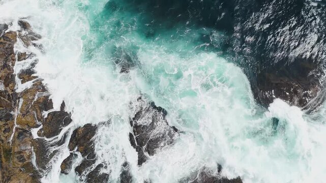 Top View Foam On Sea Waves Crashing On Rocky Coast Nova Scotia Canada. Aerial Drone Footage Capturing The Energy Of Powerful Ocean Waves Hitting The Rugged Reefs Along The Canadian Shoreline.