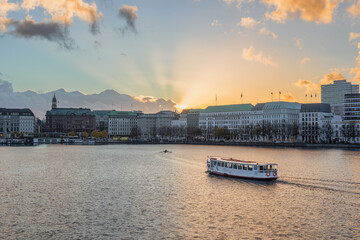 View of the Alster lake with an Alster steamer at golden hour