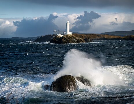 waves hitting a lighthouse in scotland - Powered by Adobe