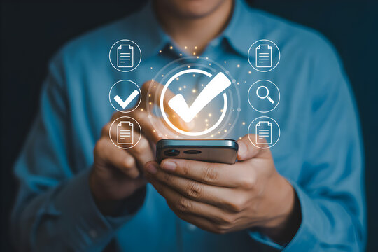 Man uses smartphone with checkmark and document icons for digital verification showcasing online security and data validation in a modern technology setting for business applications - Powered by Adobe