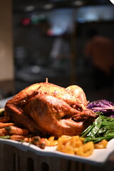 Christmas dinner plate featuring roasted turkey with root vegetables, Brussels sprouts, mashed potatoes, green beans, carrots, fresh salad, plus classic sides like stuffing, gravy and cranberry sauce.