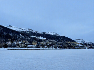 Alpine Village by a Frozen Lake in Winter