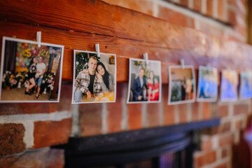 Colorful photographs hanging on a wooden mantelpiece, showcasing joyful moments and memories, creating a warm and inviting atmosphere for family gatherings and celebrations