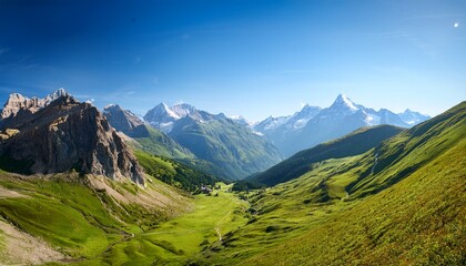 majestic mountain range and peaceful valley under clear sky
