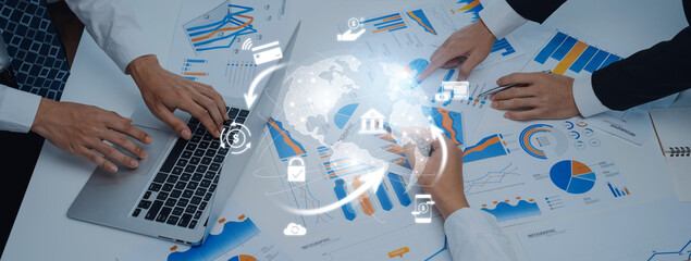 A professional team analyzes financial data and trends using charts and graphs, demonstrating collaboration and modern technology in a dynamic workspace. Trope