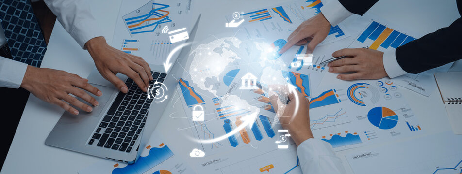 A professional team analyzes financial data and trends using charts and graphs, demonstrating collaboration and modern technology in a dynamic workspace. Trope