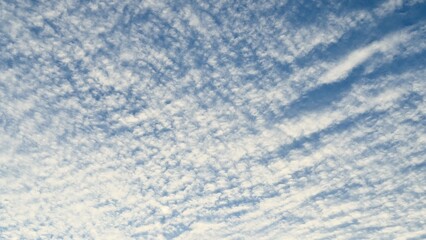 Wavy Altocumulus clouds against the backdrop of the daytime sky  a natural texture for meteorological materials, seasonal design, educational content, and atmospheric projects.
