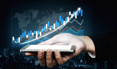 A businessman is holding a smartphone while a digital financial chart displays market growth, illustrating investment opportunities and data analysis. Impute