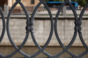 A Close-Up Of A Vintage Black Wrought Iron Fence With A Rhythmic Geometric Pattern And Decorative Elements.