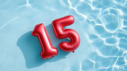 Red balloon numbers 15 floating in clear blue water, creating a vibrant and festive atmosphere for celebrations and special occasions