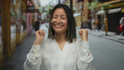 Woman smiling outdoors on busy city street showcasing joy and confidence with a vibrant urban background and casual attire reflecting a lively day
