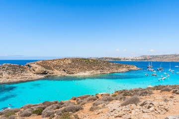 Aerial and panoramic view of the Blue Lagoon in Comino, Cominotto beach and Gozo island on the horizon, MALTA